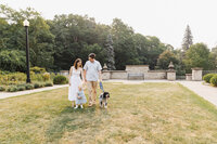 Candid moment of family and pet dog captured during family photos in Alexander Muir Memorial Gardens.