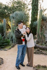 Family of three giving their daughter a hug in golden hour light, Silicon Valley family portraits