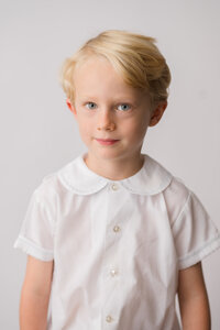 Little boys poses for Classic Heirloom Portraits in Charleston, South Carolina.