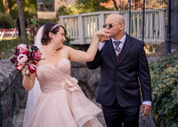 Groom kissing brides hand while the walk along the cliffside at the Columbia Gorge Hotel before their wedding.
