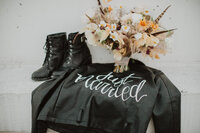 bride jacket, boots, and flowers