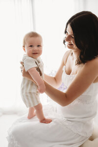 Charleston Mini Sessions - Mother embraces her baby during Mother's Day Mini Session at Holy City Babies in Charleston, SC.