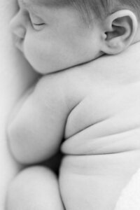 Close up newborn curled rolls during in-home session South Florida