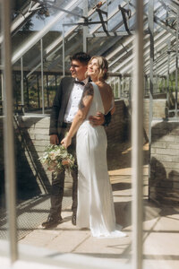 Romantic portrait of a bride and groom posing in the lush palace gardens in Prague