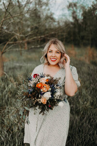 woman smiling and holding bridal bouquet