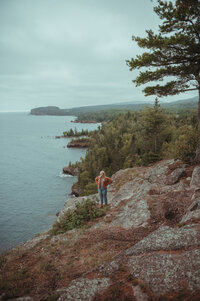 a photographer standing on a bluff in duluth minnesota