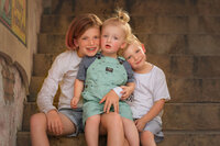three children sitting together outdoors in New Bern North Carolina