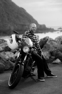 man on motorcycle engagement photos on pacifica beach