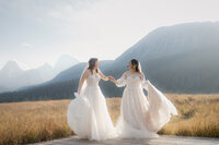 Same sex couple dancing in Mt.Engadine meadow in Kananaskis.