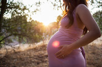 close-up of pregnant belly during outdoor maternity photography session in Glendale