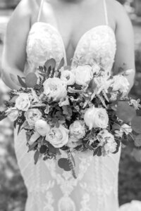 black and white photo of bride holding  a bouquet at the Willows, Lubbock, TX