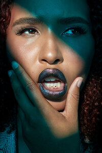 Jazz Walters in an intense, high-contrast portrait with striking makeup and vibrant colors, captured by Ylva Erevall.
