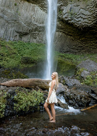 Oregon City high school senior girl standing in front of Latourell Falls senior portraits in the Columbia River Gorge.