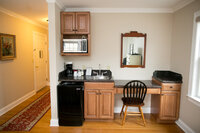 King bed guest room at Crossed Keys Inn with cozy linens desk and full bath for overnight wedding guests