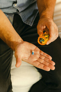 Close frame of a capsule tipped into an open palm at home
