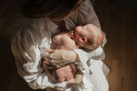 mom-newborn-overhead-golden-window-light-white-blouse-in-home-boulder-photographer-281