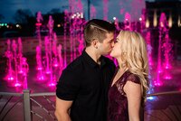 Couple Kissing in front of pink water fountain at The Fountains in Murfreesboro