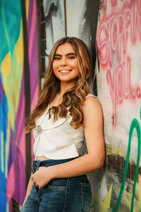 Senior portrait in downtown Mobile, Alabama — posing in front of some artwork.