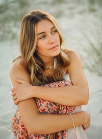 Senior portrait in Gulf Shores, Alabama — sitting on the beach.