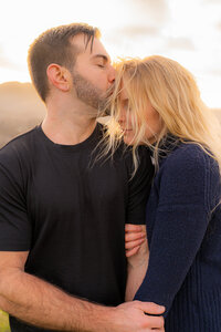 couple in mountains kissing forehead in california