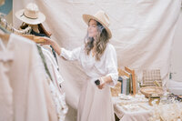 Crafting her display table at Art and Flea Market, Anna Sachs prepares for a successful day of selling vintage goods