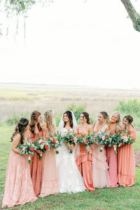 Colorful pink bridesmaids dresses on an outdoor wedding in Savannah