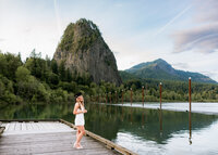 Girl wearing white dress getting senior portraits done at the dock at Beacon Rock State Park.