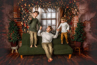 Allie Cline children bouncing on a couch in a cozy holiday home setting