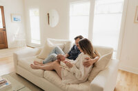 parents-newborn-cream-sofa-living-room-natural-light-in-home-boulder-photographer-155