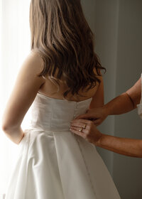 One of the most intimate moments between a mother and her daughter has to be a mom helping the bride into the gown.