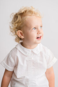 Toddler poses for Traditional, Southern Heirloom Portraits in Charleston, South Carolina.