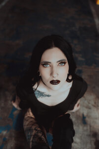 Stylized editorial portrait of an artist in a fitted fashion look.