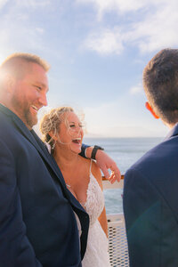 hornblower cruise wedding reception bride and groom with wedding guests on deck