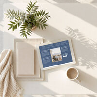iPad mockup of the Coastal Dream one-page website template resting on a wooden outdoor table