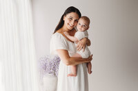 Charleston Motherhood Photographer - Mother poses with her baby during studio Mother's Day Mini Sessions at Holy City Babies Portrait Studio in Charleston, SC.