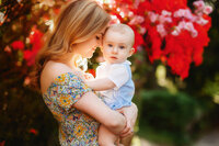 Charleston Baby Milestone Photographer - Mother embraces her baby during Family Photoshoot in Charleston, SC.
