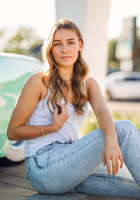 Senior portrait at Sunliner Diner in Gulf Shores, Alabama — outside the diner with a blue classic
car behind her.