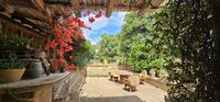 Italian stone courtyard with chairs and tables