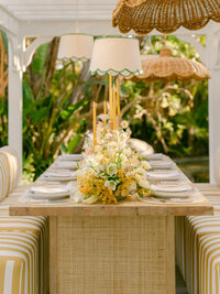 Basking in the golden glow of a citrus summer at the iconic Bahia Resort in San Diego, I had the absolute pleasure of capturing a scene of serene elegance. Tucked away in a secluded tropical garden, a charming pergola set the stage for beautifully arranged florals and meticulously styled table settings—a true mid-century retreat infused with modern whimsy. Every detail, from the vibrant citrus accents to the delicate blossoms, spoke of timeless sophistication and effortless charm.