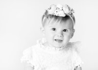high-key-black-and-white-photo-of-little-girl-with-flower-headband