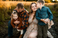 a mother cuddles her children during their fall family session in farmersville, texas