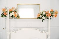 Peach and white roses decorating a mantle. Florals by Flowergirl Cville and Photography by Lyn Waldrop.