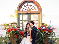 Bride and Groom in front of floral installation