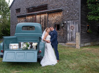 Bride and groom barn wedding antique car