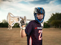 Senior portrait at Battleship Memorial Park in Mobile, Alabama— wearing his lacrosse helmet