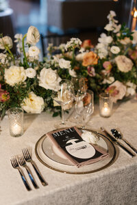 Black tie wedding tablescape with gold chargers