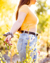 AZ dad hugging his pregnant wife next to Phoenix  saguaro cactus for photography session