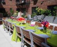 A colorful green outdoor event table setting.
