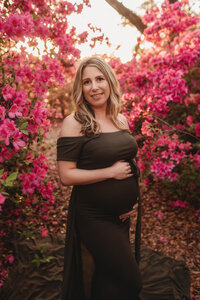 Expectant mother poses for Spring Maternity Portraits with Azalea blooms in Charleston, SC.