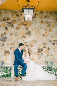 Elegant wedding ceremony at Bella Collina in Montverde, Florida, featuring a bride and groom surrounded by Tuscan-inspired architecture, lush gardens, rolling hills, and picturesque lake views.